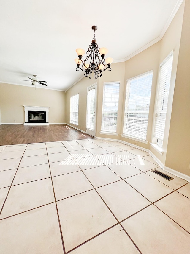 1021 Colo Trl, Antioch, TN 37013 - unfurnished living room with tile patterned floors, a chandelier, ornamental molding, baseboards, and a glass covered fireplace