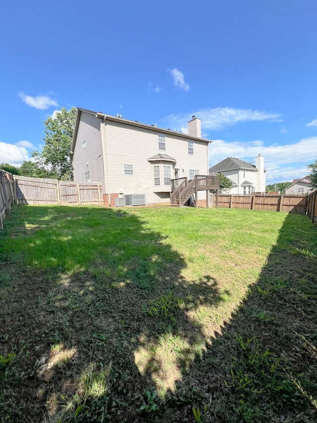 1021 Colo Trl, Antioch, TN 37013 - rear view of house featuring stairs, a chimney, and a wooden deck