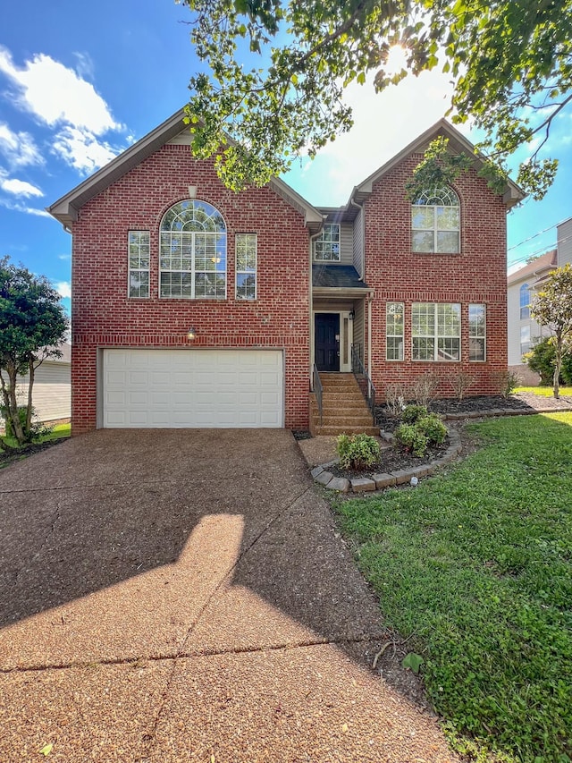 1021 Colo Trl, Antioch, TN 37013 - traditional-style house featuring driveway, brick siding, and a garage