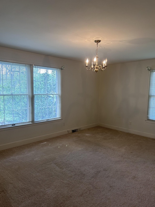 314 Powder Mill Dr, Ashland City, TN 37015 - unfurnished room featuring a chandelier, baseboards, and light carpet