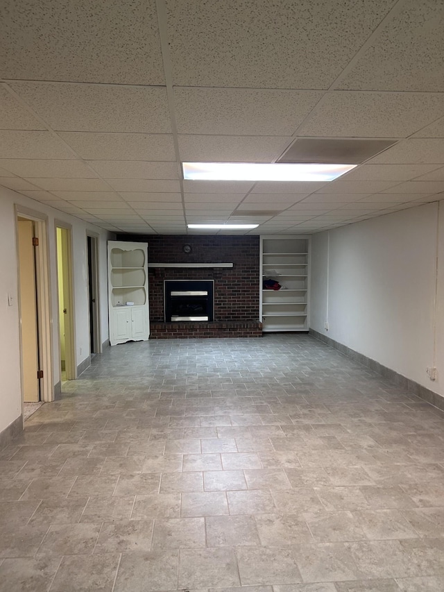 314 Powder Mill Dr, Ashland City, TN 37015 - unfurnished living room with a brick fireplace, baseboards, and a paneled ceiling