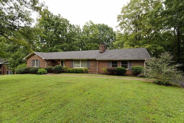 314 Powder Mill Dr, Ashland City, TN 37015 - single story home featuring brick siding, a front yard, a chimney, and view of scattered trees