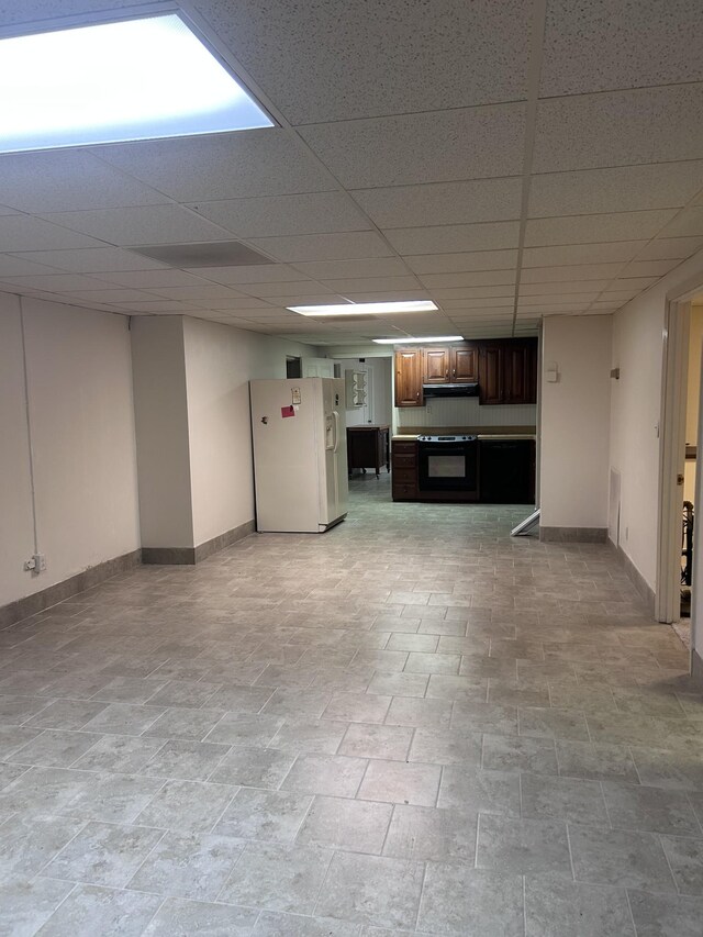 314 Powder Mill Dr, Ashland City, TN 37015 - finished basement with white refrigerator with ice dispenser, baseboards, light stone finish floors, and a paneled ceiling