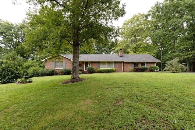 314 Powder Mill Dr, Ashland City, TN 37015 - single story home with a chimney, brick siding, and a front lawn
