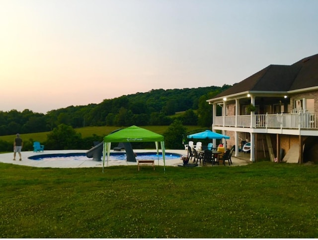 4095 Indian Hills Rd, Columbia, TN 38401 - pool at dusk with a yard, an outdoor pool, a patio, and a gazebo