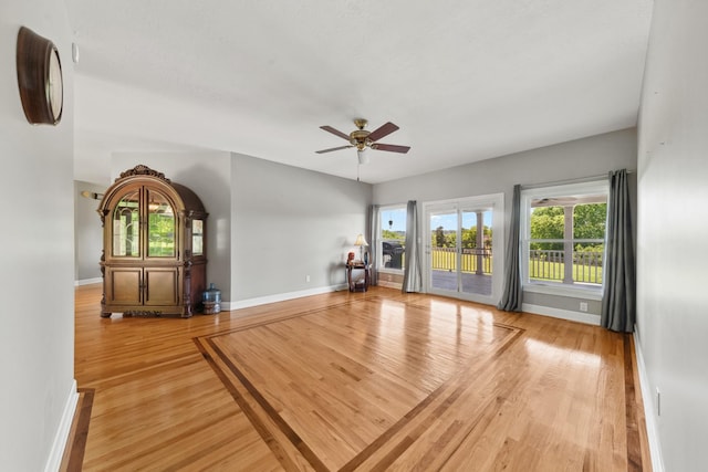 4095 Indian Hills Rd, Columbia, TN 38401 - unfurnished living room with light wood finished floors, baseboards, and a ceiling fan