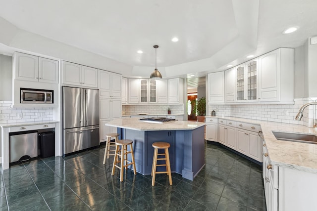 4095 Indian Hills Rd, Columbia, TN 38401 - kitchen with stainless steel appliances, a sink, a center island, decorative backsplash, and recessed lighting
