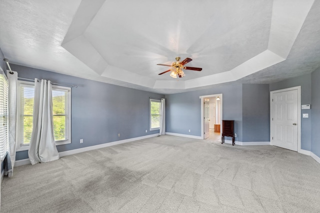 4095 Indian Hills Rd, Columbia, TN 38401 - carpeted empty room featuring a tray ceiling, baseboards, ceiling fan, and plenty of natural light