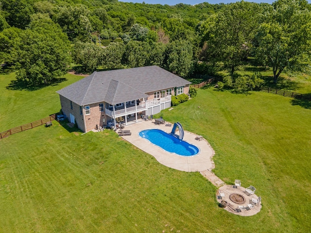 4095 Indian Hills Rd, Columbia, TN 38401 - view of swimming pool with an outdoor fire pit, a water slide, a patio, a wooden deck, and a view of trees