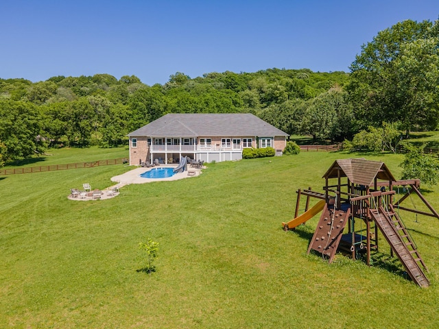 4095 Indian Hills Rd, Columbia, TN 38401 - back of property with an outdoor pool, a view of trees, and a playground