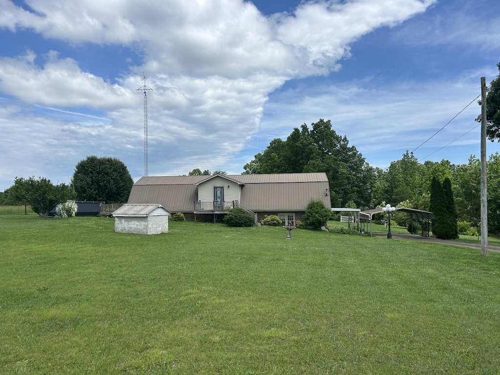 236 Beartown Rd, Loretto, TN 38469 - view of green lawn featuring an outdoor structure, a detached carport, and a shed
