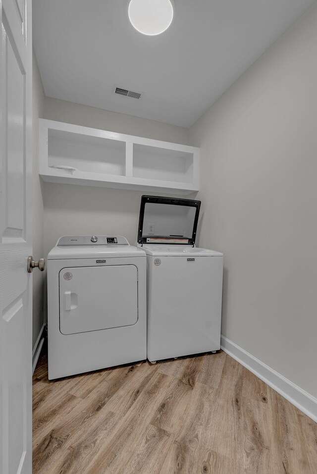 2015 Keene Cir, Spring Hill, TN 37174 - laundry room featuring washing machine and dryer, light wood-style flooring, and baseboards