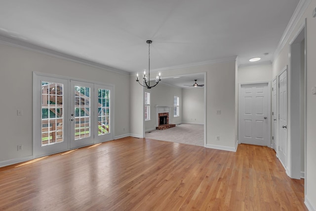 2015 Keene Cir, Spring Hill, TN 37174 - unfurnished living room with crown molding, light wood-style flooring, french doors, a chandelier, and baseboards