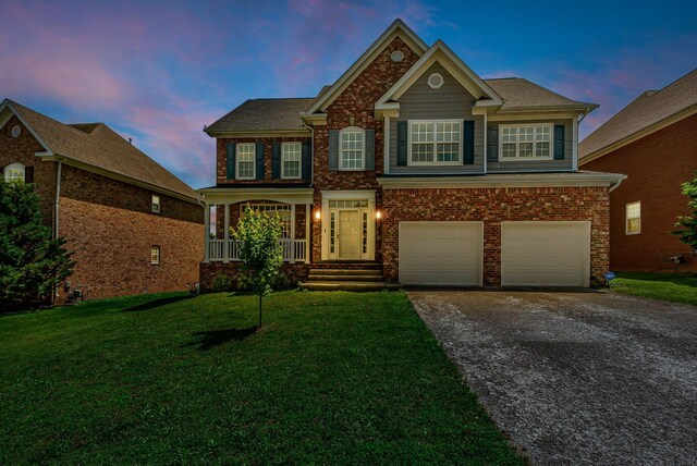2015 Keene Cir, Spring Hill, TN 37174 - view of front of property featuring driveway, an attached garage, a front lawn, a porch, and brick siding