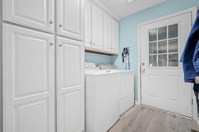 278 Riddle Rd, Manchester, TN 37355 - laundry area with cabinet space, washer and clothes dryer, light wood-style flooring, and a textured ceiling
