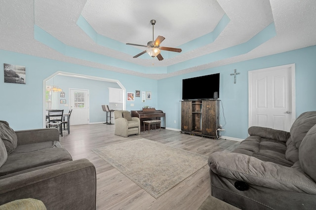 278 Riddle Rd, Manchester, TN 37355 - living area with wood finished floors, ceiling fan, baseboards, and a tray ceiling