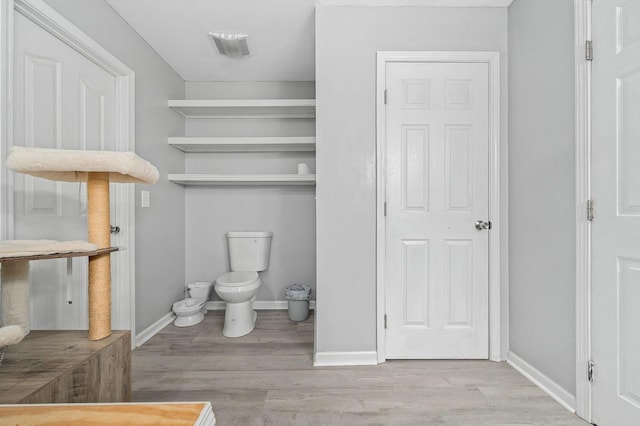 278 Riddle Rd, Manchester, TN 37355 - bathroom with wood finished floors, toilet, and baseboards
