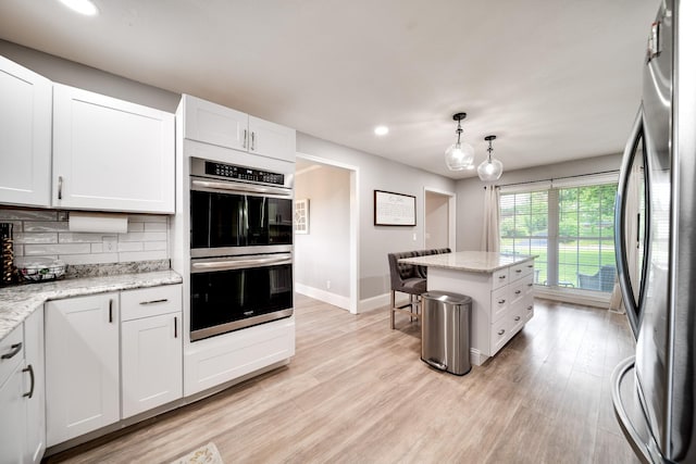 1112 Belmont Dr, Cookeville, TN 38506 - kitchen with appliances with stainless steel finishes, decorative backsplash, baseboards, recessed lighting, and light wood-type flooring