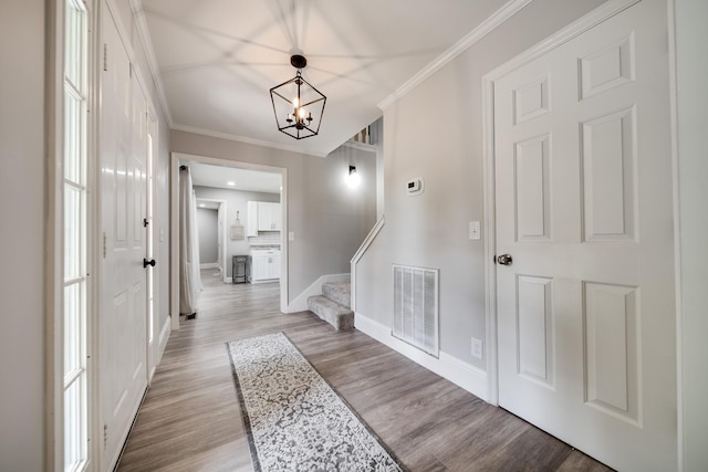 1112 Belmont Dr, Cookeville, TN 38506 - entrance foyer with light wood finished floors, crown molding, a chandelier, stairs, and baseboards