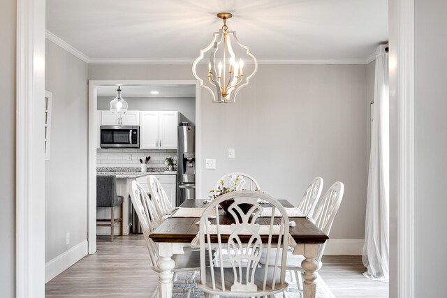 1112 Belmont Dr, Cookeville, TN 38506 - dining area with light wood-type flooring, baseboards, crown molding, and a chandelier