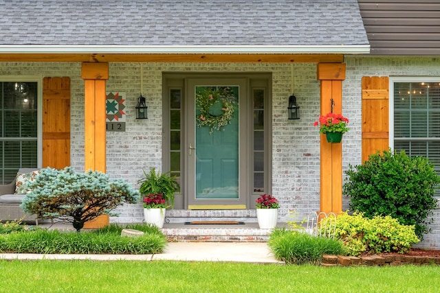 1112 Belmont Dr, Cookeville, TN 38506 - doorway to property featuring roof with shingles, brick siding, and covered porch