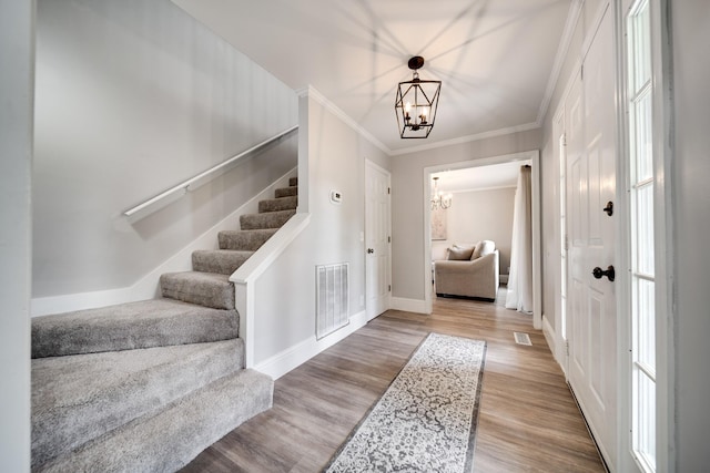 1112 Belmont Dr, Cookeville, TN 38506 - entryway featuring a chandelier, stairs, wood finished floors, baseboards, and crown molding