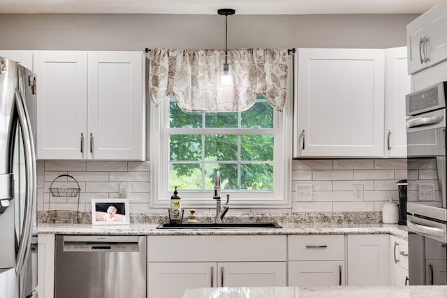 1112 Belmont Dr, Cookeville, TN 38506 - kitchen with stainless steel appliances, a sink, white cabinetry, and backsplash
