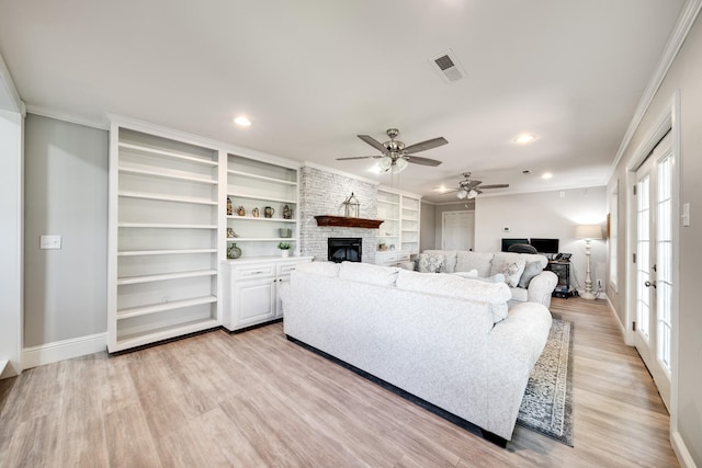 1112 Belmont Dr, Cookeville, TN 38506 - living room with a stone fireplace, baseboards, light wood finished floors, crown molding, and built in shelves