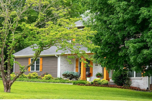 1112 Belmont Dr, Cookeville, TN 38506 - view of property hidden behind natural elements with brick siding, a front yard, and roof with shingles