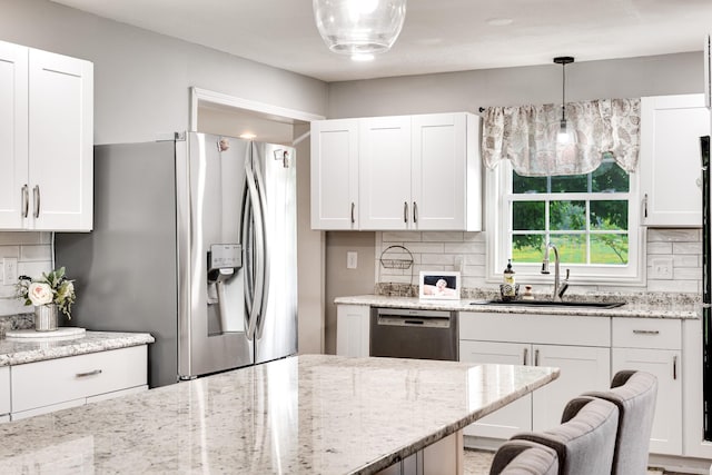 1112 Belmont Dr, Cookeville, TN 38506 - kitchen with appliances with stainless steel finishes, a sink, backsplash, and light stone counters