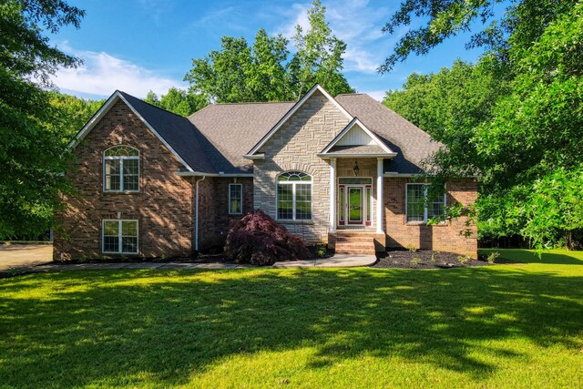 358 Spring Valley Dr, Cottontown, TN 37048 - view of front of house with a front lawn, brick siding, a shingled roof, and stone siding