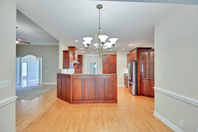 358 Spring Valley Dr, Cottontown, TN 37048 - kitchen featuring freestanding refrigerator, arched walkways, light wood-style floors, a chandelier, and a peninsula