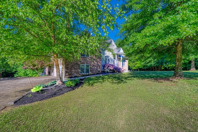 358 Spring Valley Dr, Cottontown, TN 37048 - view of green lawn featuring asphalt driveway