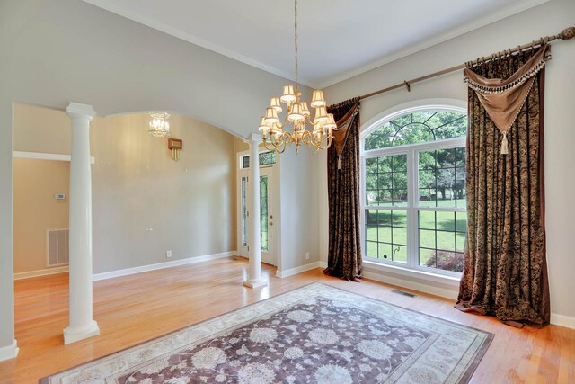 358 Spring Valley Dr, Cottontown, TN 37048 - unfurnished dining area featuring a chandelier, ornate columns, wood finished floors, baseboards, and crown molding