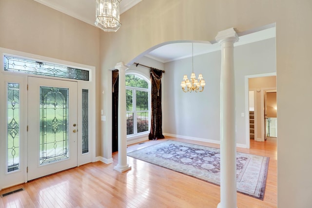358 Spring Valley Dr, Cottontown, TN 37048 - foyer with a chandelier, wood finished floors, ornamental molding, arched walkways, and decorative columns