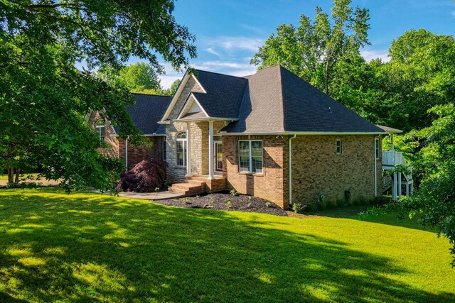 358 Spring Valley Dr, Cottontown, TN 37048 - view of front of house with a front lawn, roof with shingles, brick siding, and stone siding