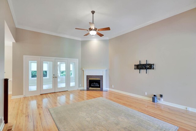 358 Spring Valley Dr, Cottontown, TN 37048 - unfurnished living room featuring a ceiling fan, light wood finished floors, ornamental molding, a fireplace with flush hearth, and baseboards