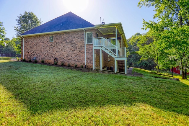 358 Spring Valley Dr, Cottontown, TN 37048 - back of property featuring stairway, brick siding, a yard, and a shingled roof