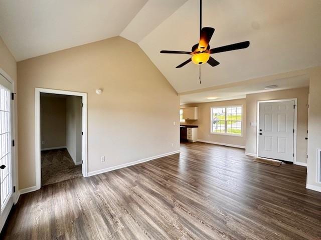 62 Modena Pl, Decherd, TN 37324 - unfurnished living room with vaulted ceiling, ceiling fan, dark wood-type flooring, and baseboards