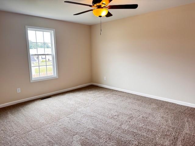 62 Modena Pl, Decherd, TN 37324 - unfurnished room with carpet flooring, a ceiling fan, and baseboards