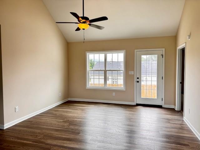 62 Modena Pl, Decherd, TN 37324 - unfurnished living room with vaulted ceiling, plenty of natural light, ceiling fan, dark wood-style floors, and baseboards