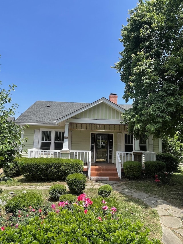 5314 Elkins Ave, Nashville, TN 37209 - view of front of property with a porch, a chimney, a shingled roof, and board and batten siding
