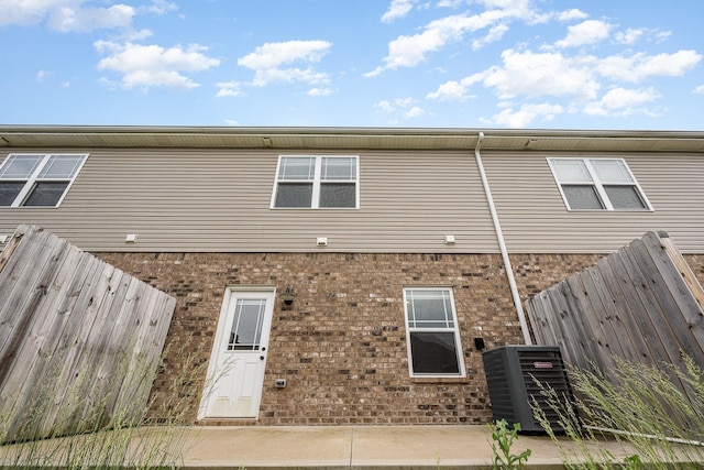 328 Fallow Cir, Clarksville, TN 37040 - rear view of house featuring central air condition unit, brick siding, and fence