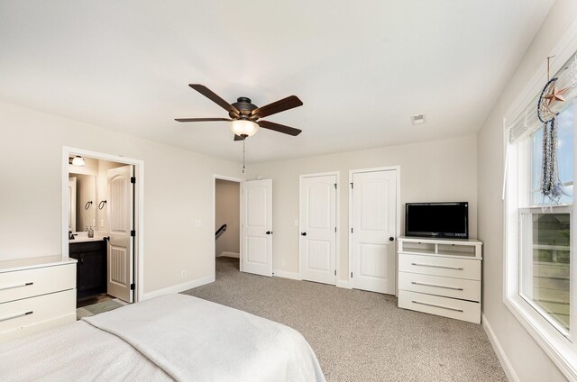 328 Fallow Cir, Clarksville, TN 37040 - bedroom with two closets, light colored carpet, baseboards, ensuite bath, and a ceiling fan