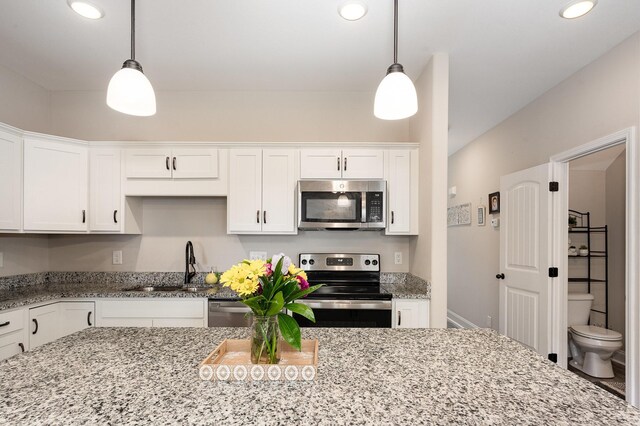 328 Fallow Cir, Clarksville, TN 37040 - kitchen with stainless steel appliances, recessed lighting, white cabinetry, decorative light fixtures, and light stone counters