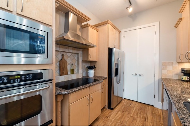 2600 Hillsboro Pike Unit 453, Nashville, TN 37212 - kitchen with wall chimney exhaust hood, stainless steel appliances, light brown cabinetry, light wood-type flooring, and tasteful backsplash