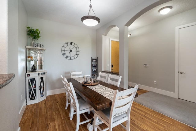 2600 Hillsboro Pike Unit 453, Nashville, TN 37212 - dining area with arched walkways, wood finished floors, and baseboards