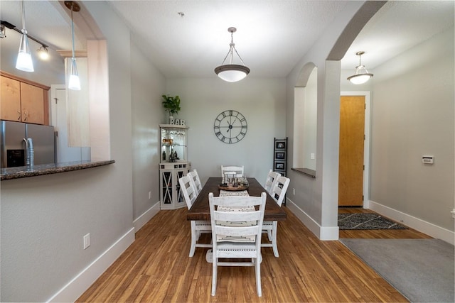 2600 Hillsboro Pike Unit 453, Nashville, TN 37212 - dining space with arched walkways, wood finished floors, and baseboards