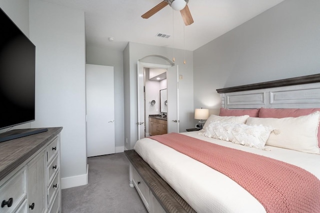 2600 Hillsboro Pike Unit 453, Nashville, TN 37212 - bedroom featuring light carpet, baseboards, ensuite bathroom, and ceiling fan