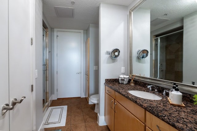2600 Hillsboro Pike Unit 453, Nashville, TN 37212 - full bath featuring a textured ceiling, a stall shower, tile patterned flooring, toilet, and vanity